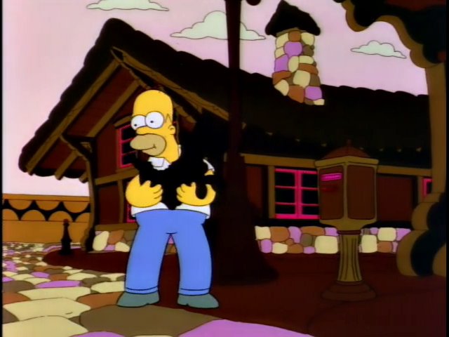 Homer enjoys eating a chocolate dog in "The Land of Chocolate" (pop. 1372)